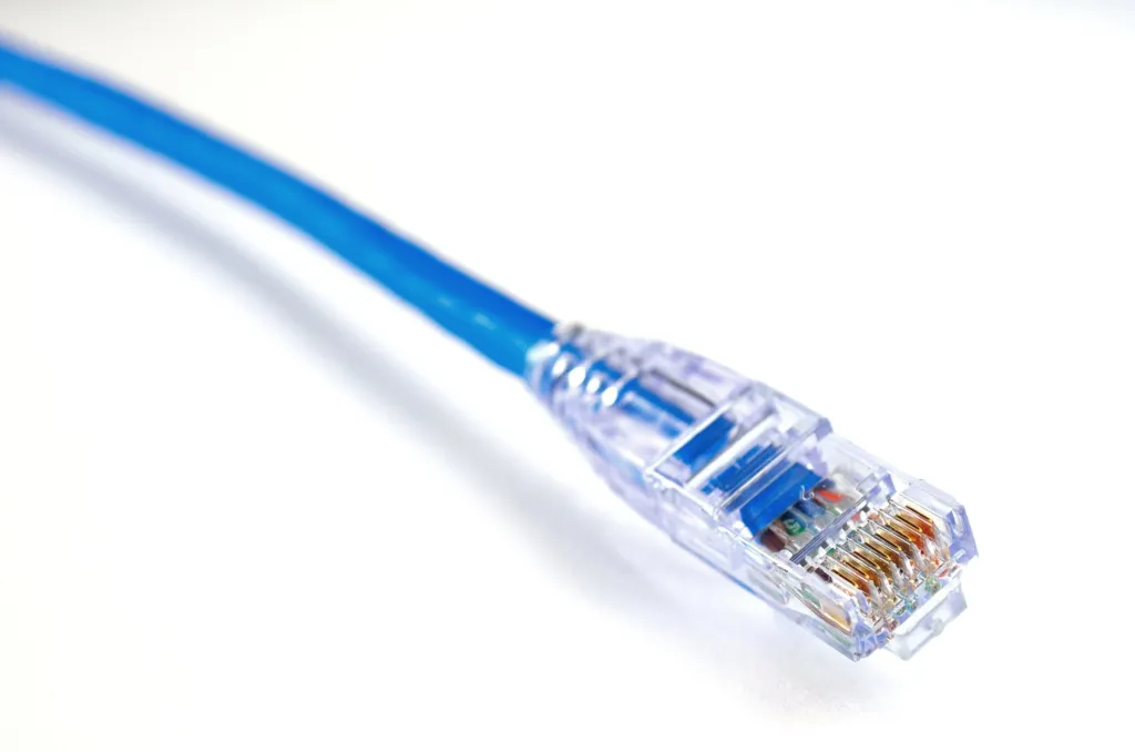 Blue network cable with an RJ45 plug on a white background